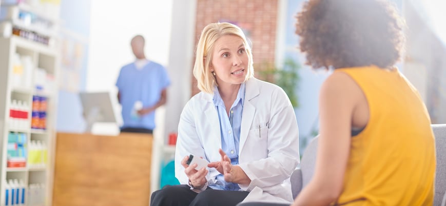 Pharmacist talking to customer